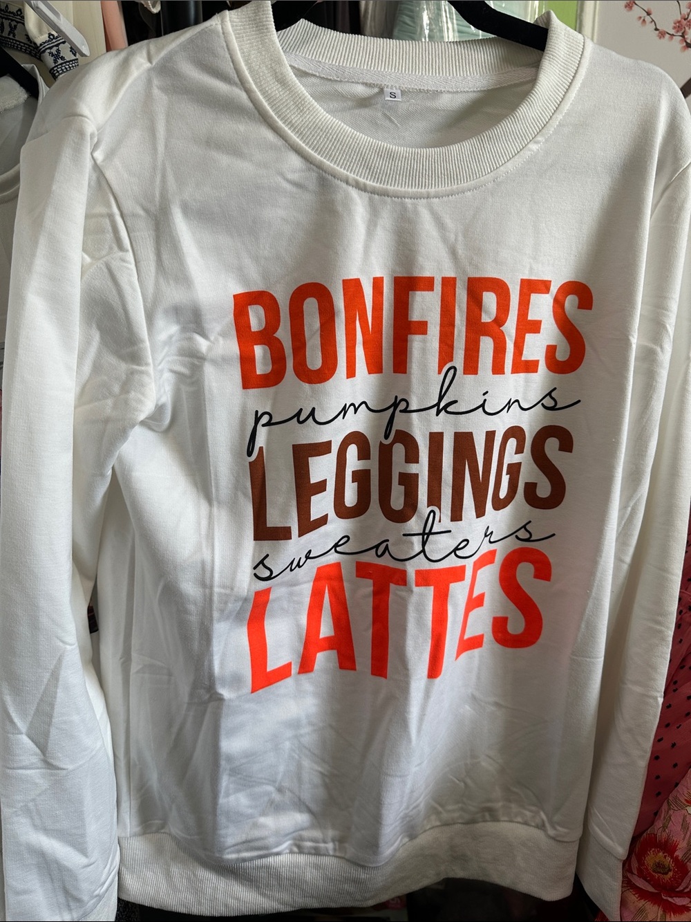 White Sweatshirt with Orange "Bonfires" Graphic